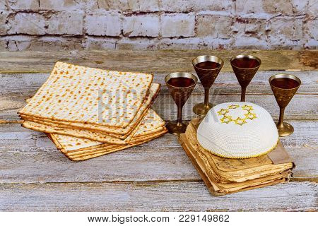 Symbols Of Passover Background. Wine And Matzoh Jewish Holiday Bread Over Wooden Board.