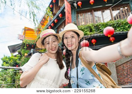 Two Girls Taking Selfie Photograph Photo On Famous Landmarks Amei Tea House On The Hill Of Jiufen.