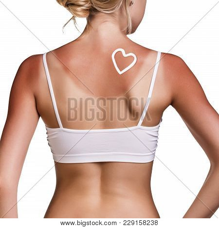 Sunblock On The Female Shoulder Isolated On White. Body Care Concept.
