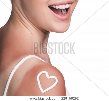 Sunblock On The Female Shoulder Isolated On White. Body Care Concept.