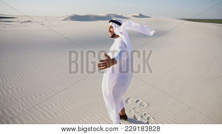 Happy Arabian Uae Sheikh Man Walks In Middle Of White Desert And