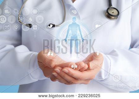 Doctor Shows A Hologram Of A Patient On A Blue Background.