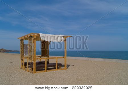 Wooden Massage Parlor With Two Tables On The Beach