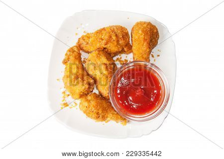 Chicken Legs In Breadcrumbs With Tomato Ketchup On A Plate Isolated On White