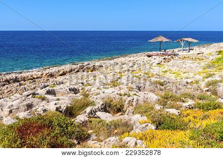 Umbrellas With Sunbeds On Porto Roxa Beach. Zakynthos Island, Greece