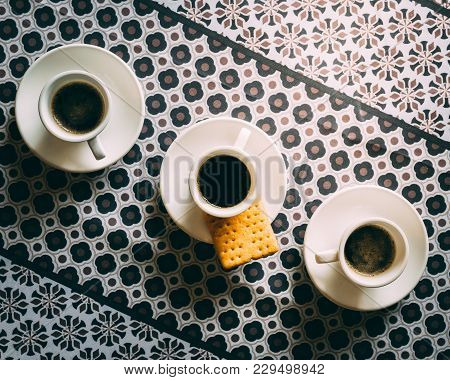 Three Espresso Coffee Cups And Saucers On Pattern Background