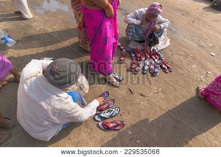 Seller Selling Shoes To Sari Clad Indian Women, Kolkata, India