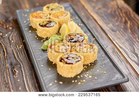 Set Of Unagi Sushi Rolls. Delicious Sushi Rolls With Eel And Avocado Served With Lemon, Wasabi And G