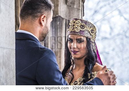 Happy Couple In Traditional Turkish Wedding Dress During Their Wedding In A Snow Storm