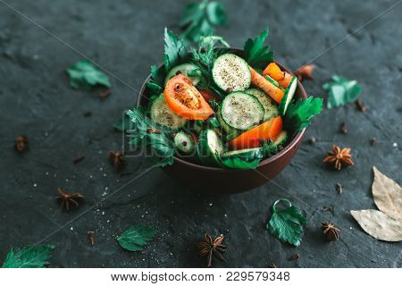 Fresh Salad With Vegetables On A Black Matte Background. The Concept Of A Healthy Diet.