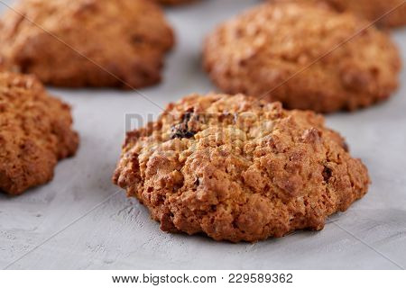 Sweet Cookies With Raisin Arranged In Pile On Light Textured Background, Close-up, Shallow Depth Of 