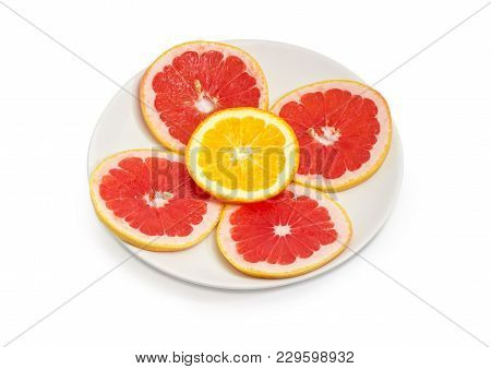 Several Round Slices Of The Ripe Red Grapefruit And One Slice Of Orange With Their Peel On The White