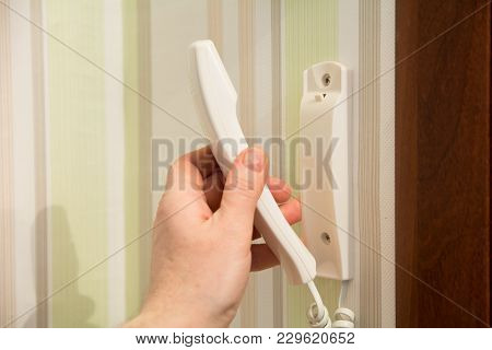 Hand Holds Hands Of Entry Phone
