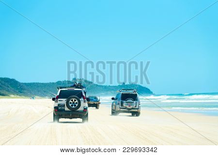 4Wd Vehicles At Rainbow Beach With Coloured Sand Dunes, Qld, Australia