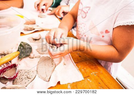 Children With Mothers Are Sculpt With Clay. Clay Therapy And Developing Fine Motor Skills. Family Da