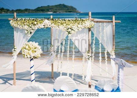 The Wedding Venue Decoration On The Beach, Arch Decorated With Flowers, Floral, The Panoramic Ocean 