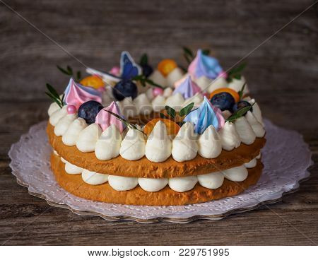 Beautiful Homemade Cake In The Form Of Six Figures With Berries And Curd Cream On A Wooden Table