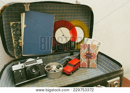 Part Of Leather Travel Valises Or Old Suitcase With Camera, Toy Car, Vintage Vinyl Record And Black 