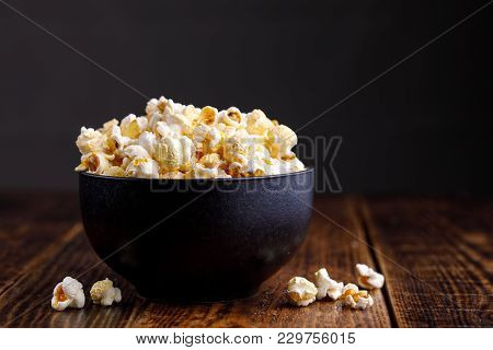 A Dark, Elegant Ceramic Bowl With Seductive Popcorn.