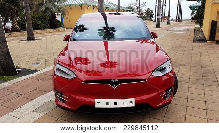 Menton, France - March 3, 2018: Red Tesla Model X Electric Car Parked On A Square In Menton On The F