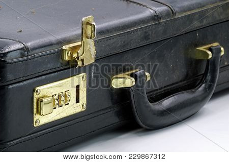 Close Up Of An Old Leather Briefcase With Golden Combination Lock.