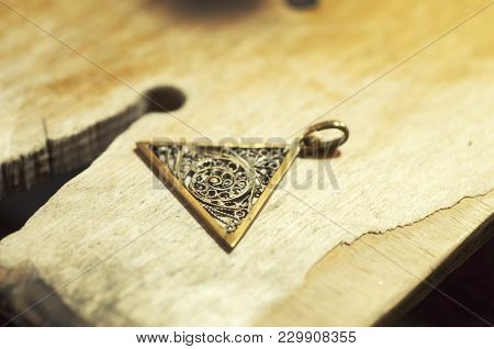 The Work Of Jewelers. Trial Jewelry Of Semiprecious Metals. Triangular Brooch With A Braided Pattern