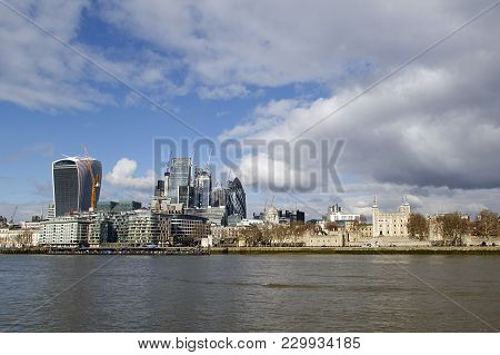 View Of The Tower Of London Alongside New Construction On The North Bank Of The Thames River. City C
