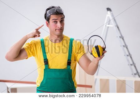 Worker showing the importnace of wearing noise cancelling headph