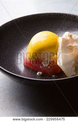 Sorbetto Ice Cream Served On A Black Bowl