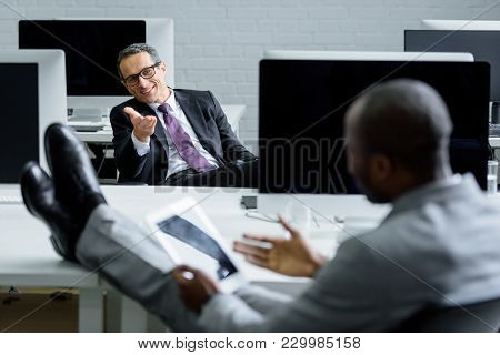 Selective Focus Of Multicultural Businessmen Having Conversation At Workplace In Office
