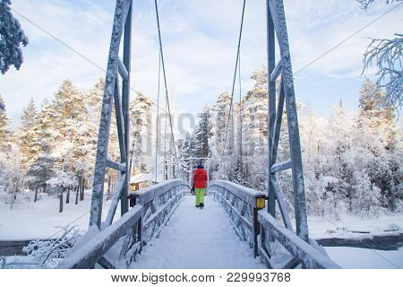 Bridge Over Half Frozen Raudanjoki Peat River On A Sunny Winter Day, Vaattunki, Finland.