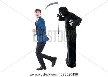 Man In A Halloween Grim Reaper Ghost Costume Chasing, Mocking And Making Fun Of Scared Businessman R