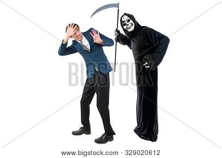 Man In A Halloween Grim Reaper Ghost Costume Chasing, Mocking And Making Fun Of Scared Businessman R