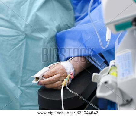 Doctor Preparing Patient For Surgery In Operating Room, Closeup
