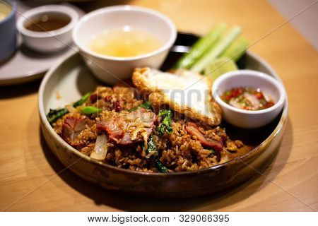 Fried Rice With Black Soy Sauce (rodfai Fried Rice) Thai Local Style With Fried Egg And Red Pork Sli
