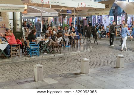 Thessaloniki, Greece - October 12 2019: Hellenic Nightlife Scene Of People At Outdoors Tavern Restau
