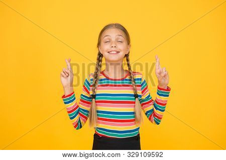 I Dont Want To Jinx It. Cute Child Make Wish Yellow Background. Little Child Keep Fingers Crossed Fo