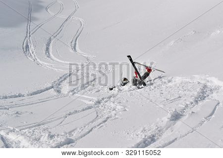 VALMOREL, FRANCE - JANUARY 31, 2019: Skier falls in deep snow free ride after heavy snowfall in Valmore, French ALps