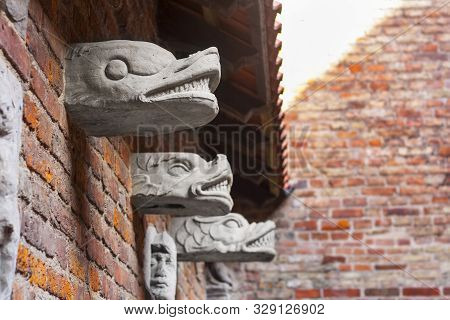Gdansk, Poland - August 23, 2019: Carvings On Bricky Wall Inside Yard Of Medieval Prison Tower And T