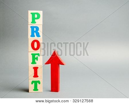 Wooden Blocks With The Word Profit And Up Arrow. Concept Of Business Success, Financial Growth And W