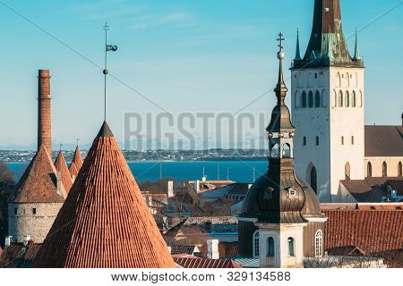 Tallinn, Estonia. Part Of Tallinn City Wall With Towers, At The Top Of Photo There Is Tower Of Churc