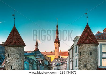 Tallinn, Estonia. Famous Landmarks Viru Gate And Town Hall On Background. Old Town. Popular Touristi