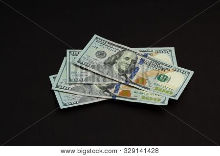 Four Banknotes Four Hundred Us Dollars On A Black Background Tied With A Green Ribbon
