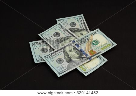 Four Banknotes Four Hundred Us Dollars On A Black Background Tied With A Green Ribbon