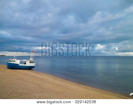 Fishing Boat On Baltic Sea Coast. Stormy Weather. Mechelinki, Poland, Pucka Bay.