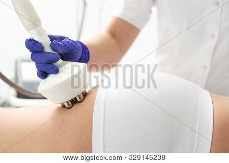 Cellulite And Fat Reduction. Woman On A Slimming Procedure Using A Head With Radio Waves