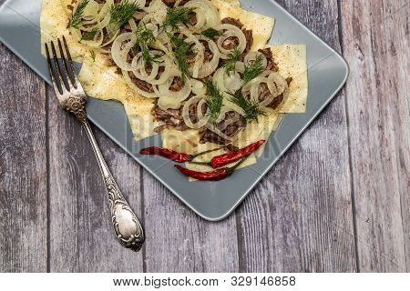 Beshbarmak Is A National Kazakh Dish - Square Pasta With Boiled Meat And Onions. On Wooden Backgroun