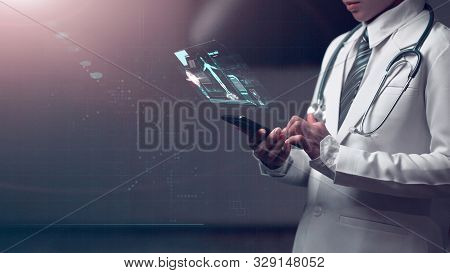 Doctor Holding Smart Device With Human Anatomy Graphic