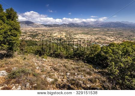 Top View Of The Lassithi Plateau On A Sunny Day With Cloudy Sky.