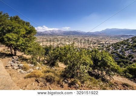 Top View Of The Lassithi Plateau On A Sunny Day With Cloudy Sky.